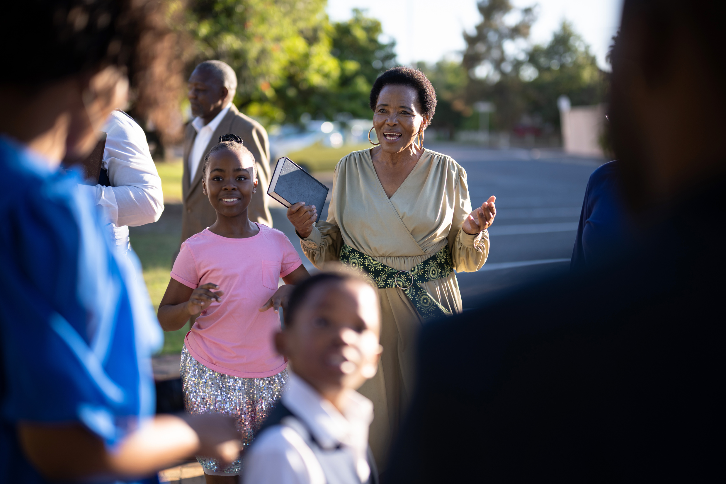 Happy grandmother greeting family outside church